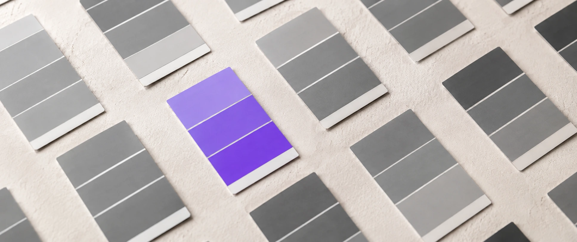 A vibrant purple paint swatch standing out among grey swatches, illustrating CTA button color