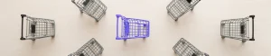 A purple shopping cart standing out among grey shopping carts, illustrating how to reduce cart abandonment