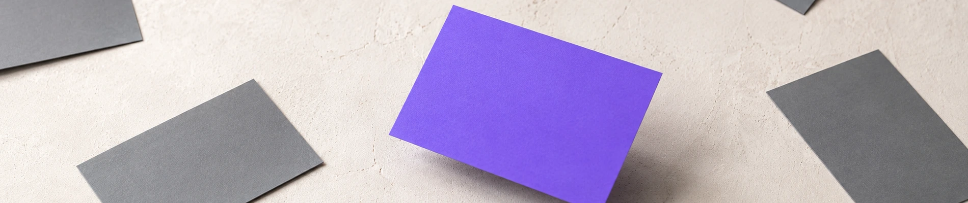 One large purple card standing out among small grey cards, illustrating visual hierarchy in web design